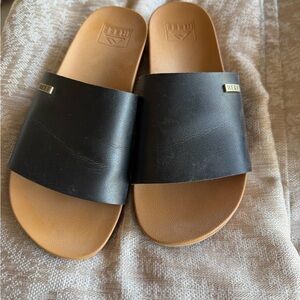 Reef Black Slide Sandals with Tan Footbed & Logo Accent